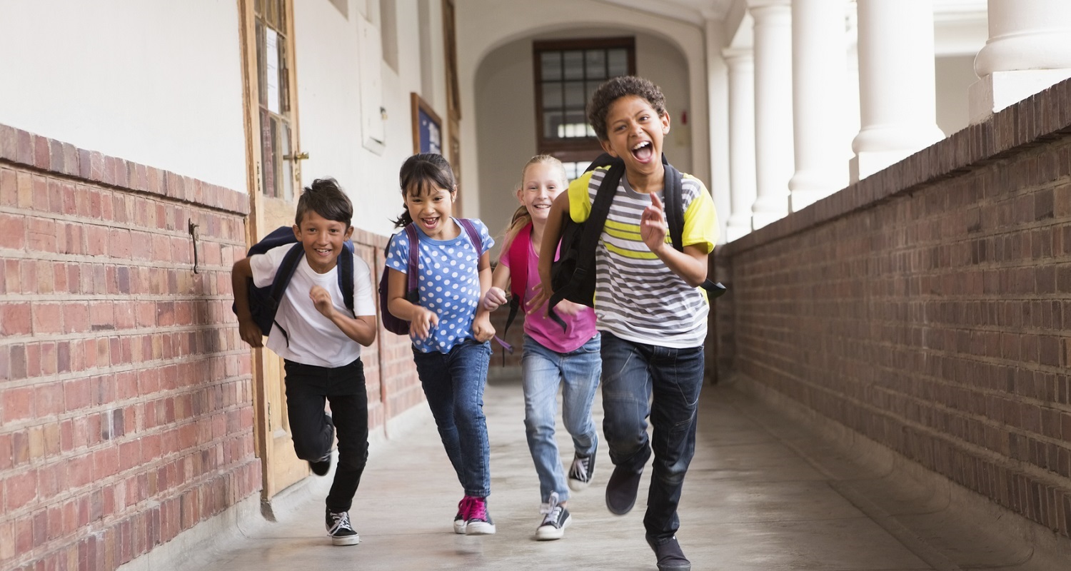 diverse kids running down hallway